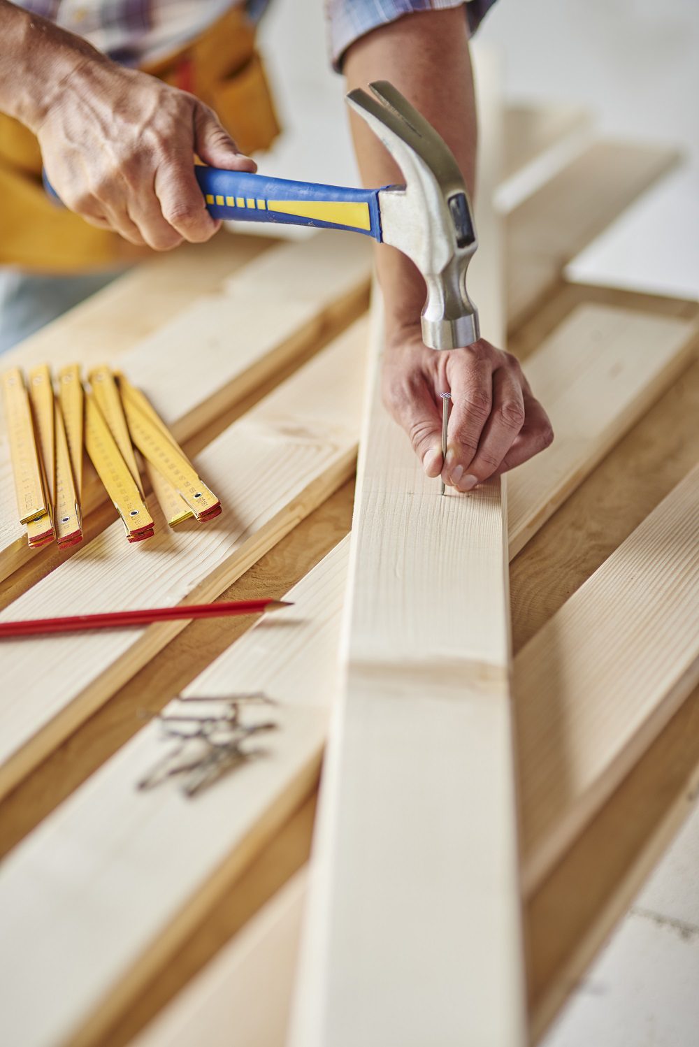 Carpenter with hammer hits wood carpenter-with-hammer-hits-wood